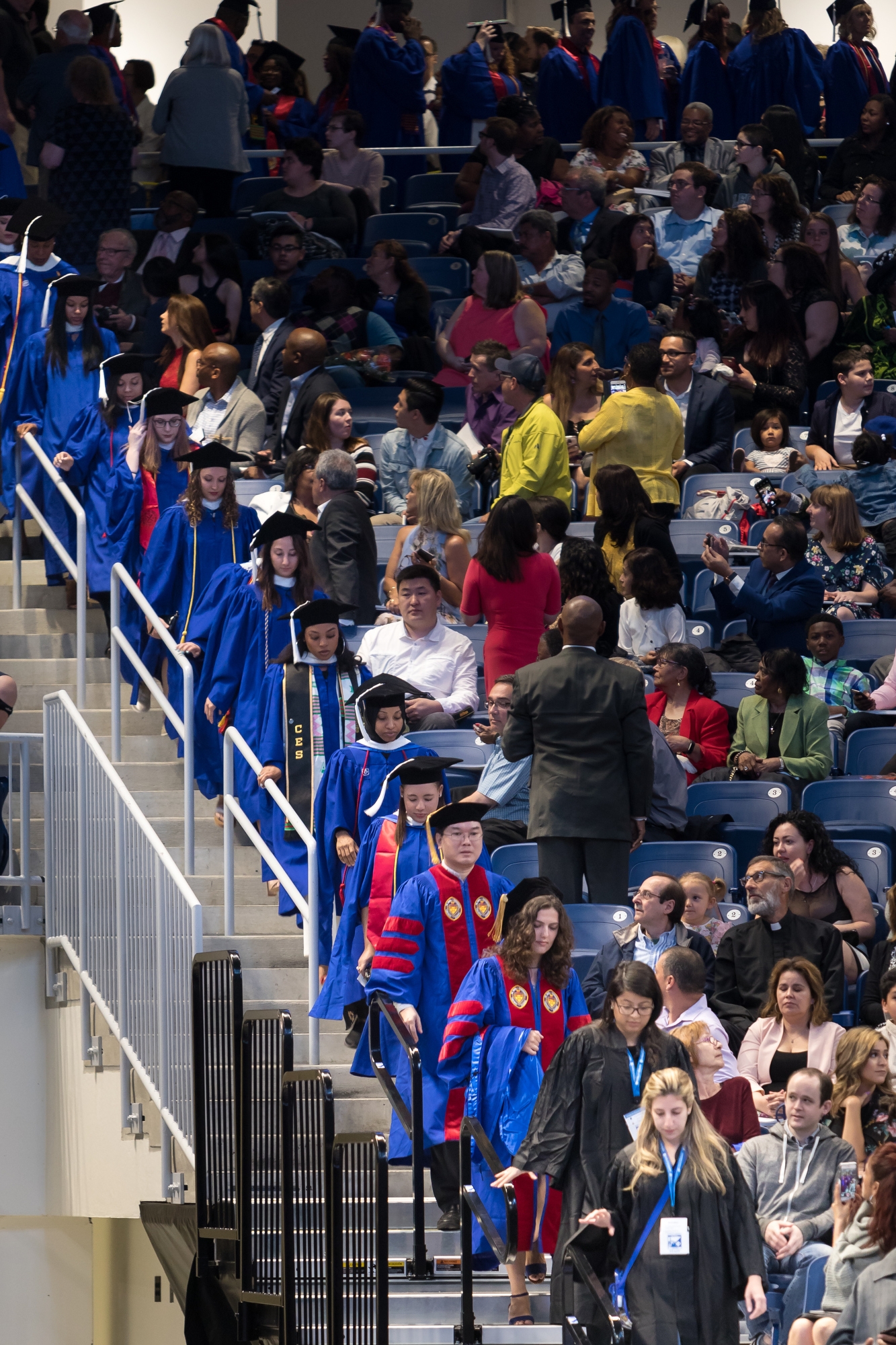 Graduates in the College of Liberal Arts and Social Sciences and the School for New Learning make their way into Wintrust Arena for their commencement ceremony. (DePaul University/Jeff Carrion)